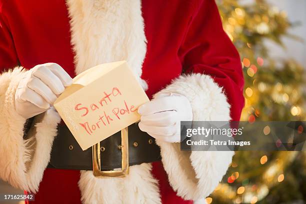 santa claus holding letter - child writing letter to santa stock pictures, royalty-free photos & images