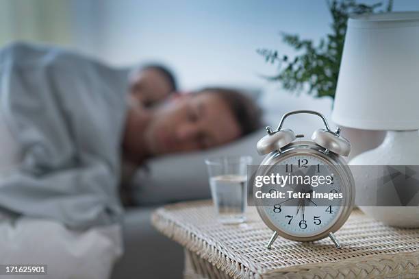 usa, new jersey, jersey city, alarm clock in bedroom - woman sleeping table stock pictures, royalty-free photos & images