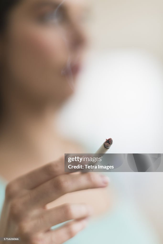 USA, New Jersey, Jersey City, Woman smoking cigarette