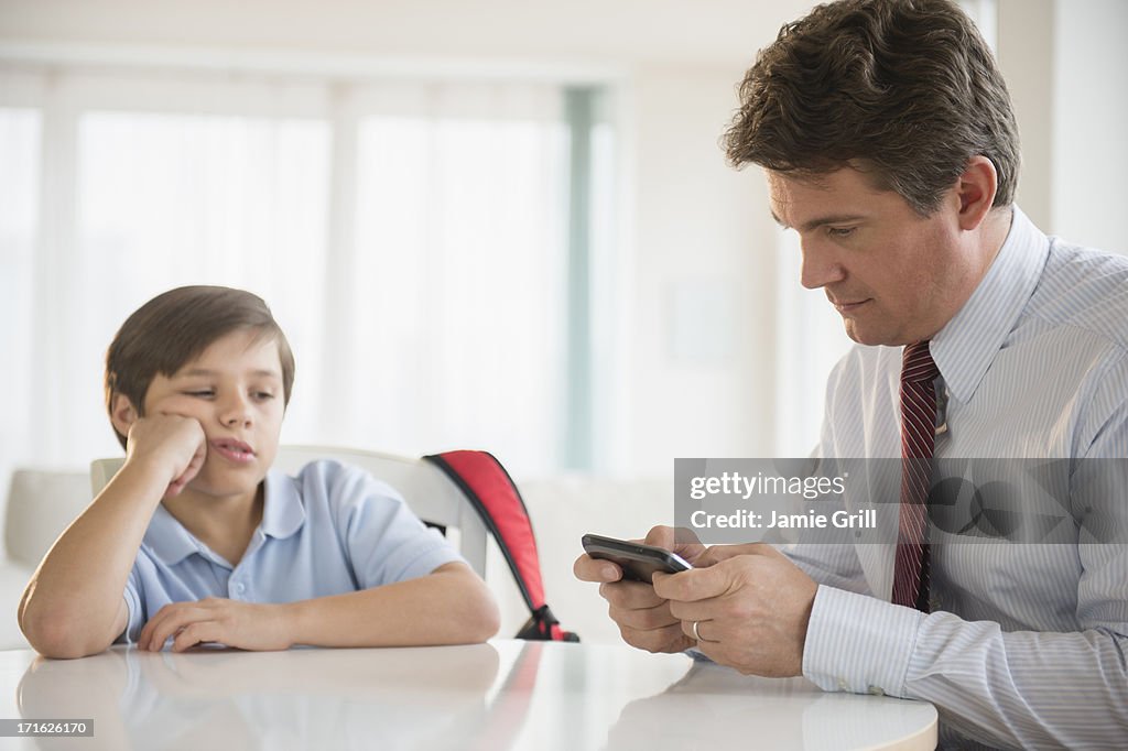 USA, New Jersey, Jersey City, Father and son (8-9) sitting at table