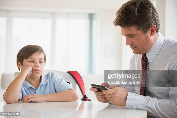 usa, new jersey, jersey city, father and son (8-9) sitting at table - ignoring stock pictures, royalty-free photos & images