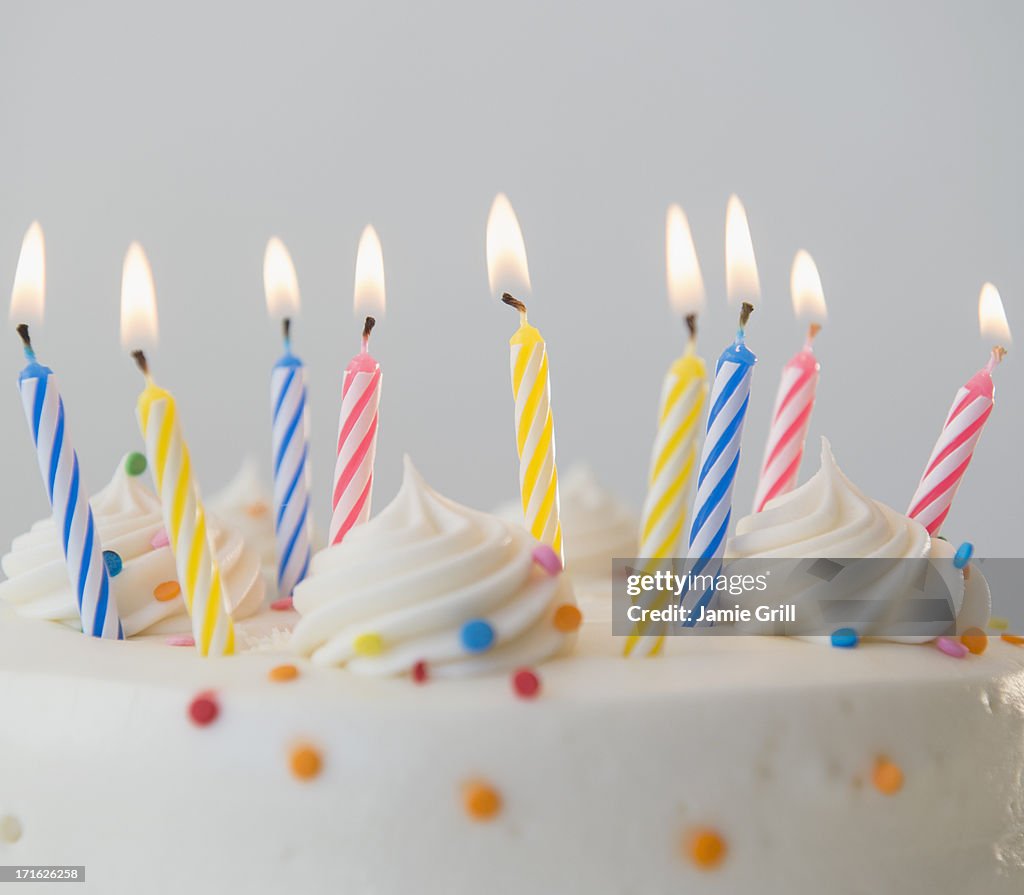 Studio shot of birthday cake with lit candles