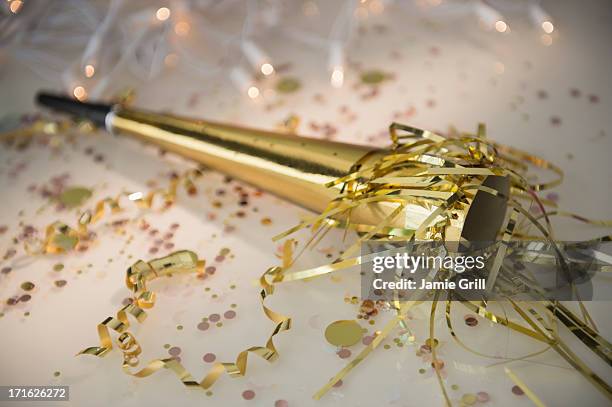 close-up of gold party horn blower - party favor foto e immagini stock