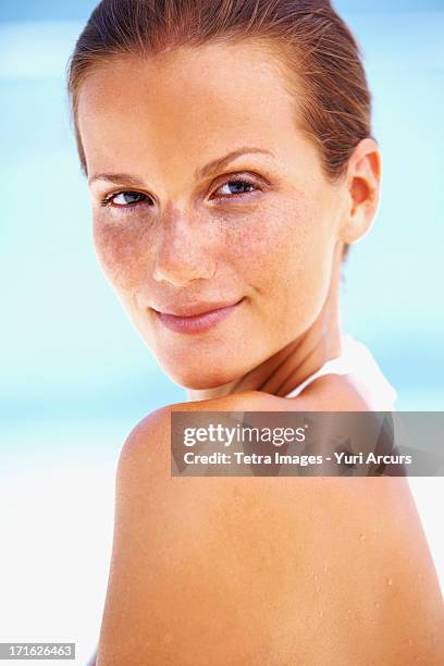 south africa, cape town, portrait of young woman looking over shoulder - beautiful woman beach stock pictures, royalty-free photos & images