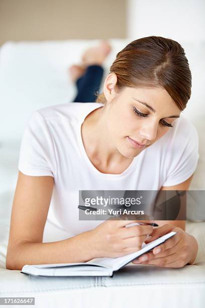 south africa, cape town, young woman lying on bed and reading - writing copy stock pictures, royalty-free photos & images