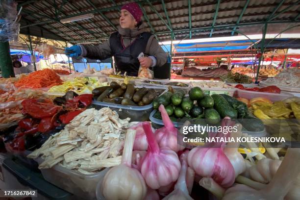 Vendor sells pickled vegetables at a market in Moscow on October 10, 2023.