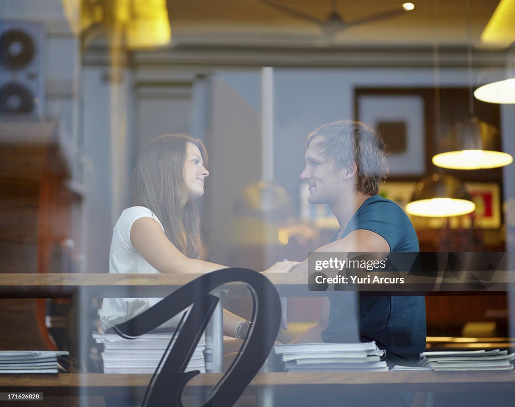 South Africa, Cape Town, Portrait of couple talking in coffee shop