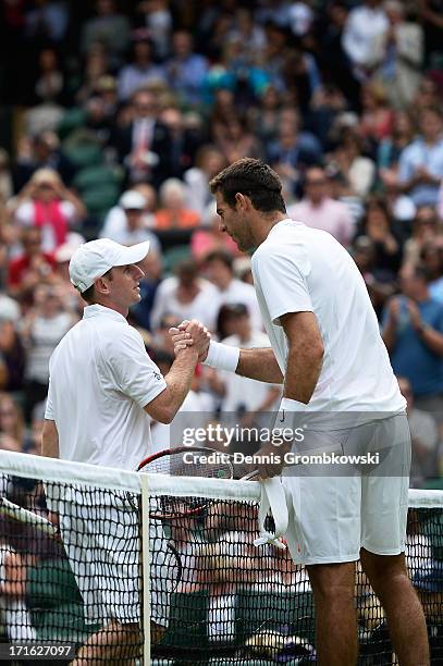 Juan Martin Del Potro of Argentina shakes hands at the net with Jesse Levine of Canada after their Gentlemen's Singles second round match on day four...