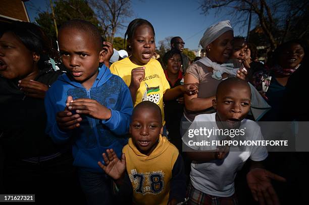 Children sing for former South African President Nelson Mandela at the Medi Clinic Heart hospital in Pretoria on June 27, 2013. Nelson Mandela...