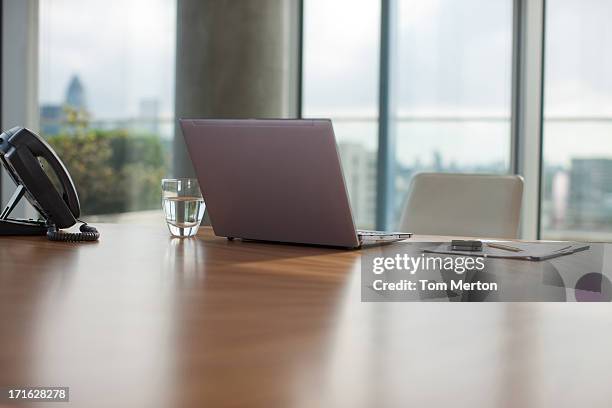 glass of water, paper, laptop and pen on conference room table - close up table stock pictures, royalty-free photos & images