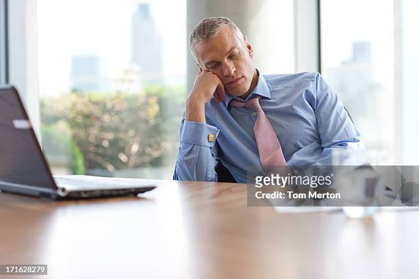 businessman napping at desk in office - boring meeting stock pictures, royalty-free photos & images