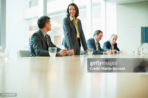 business people at conference table in office - group of businesspeople standing low angle view stock pictures, royalty-free photos & images