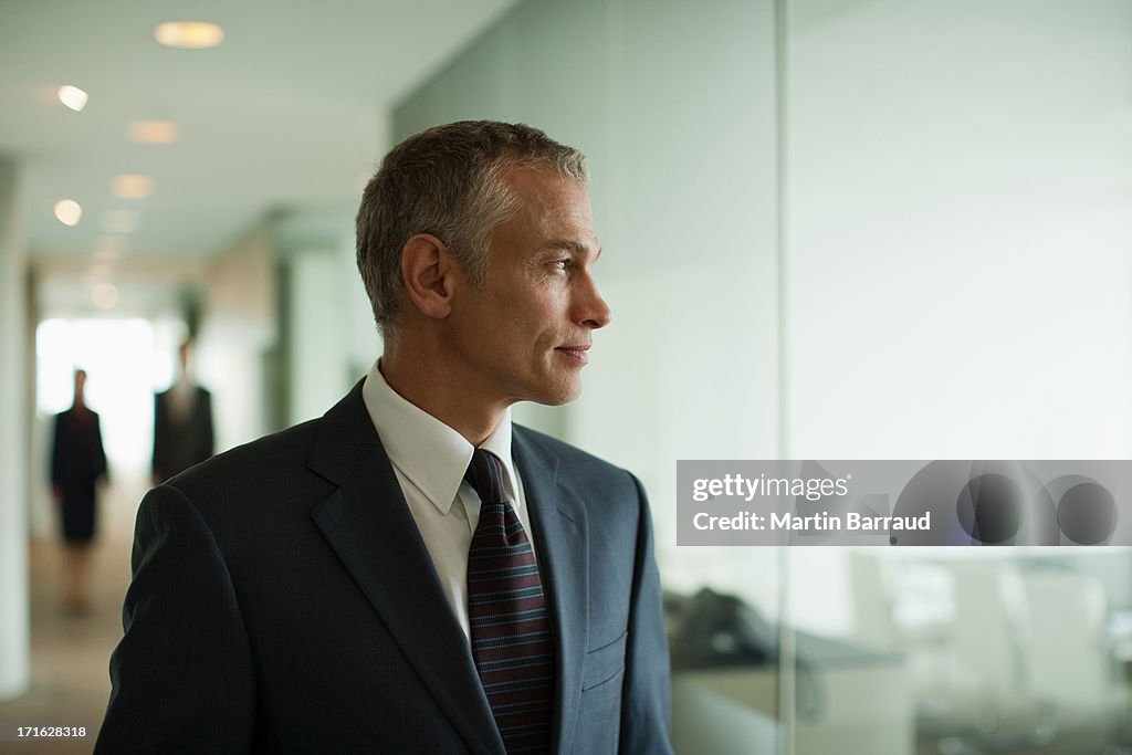 Businessman standing in busy office