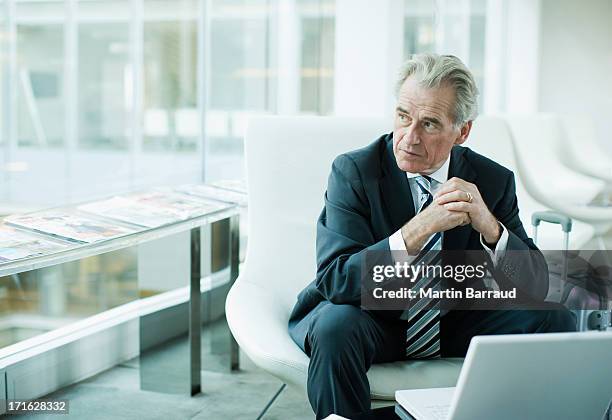 businessman using laptop while traveling - senior executives stock pictures, royalty-free photos & images