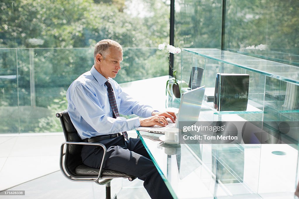 Empresário com o laptop no escritório