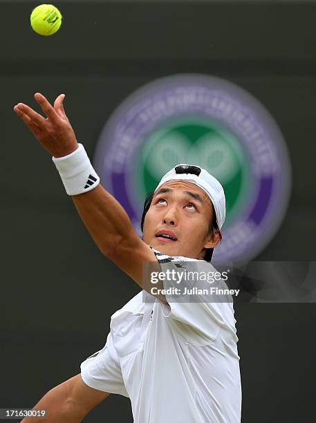 Go Soeda of Japan serves during his Gentlemen's Singles second round match against Richard Gasquet of France on day four of the Wimbledon Lawn Tennis...