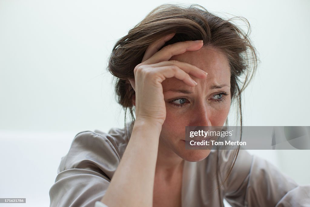 Depressed woman with head in hands