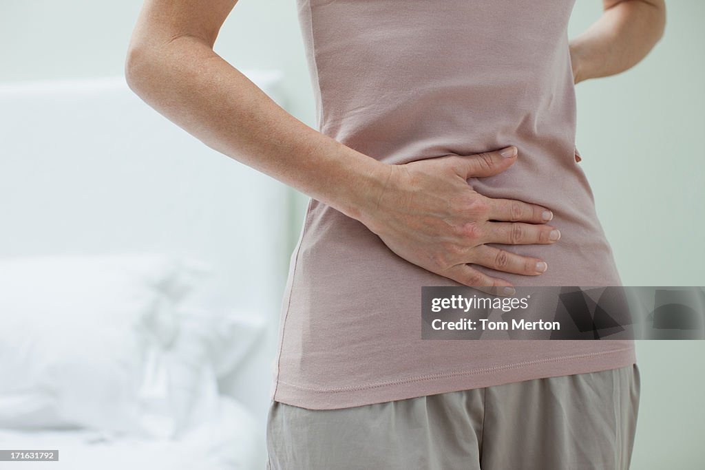 Woman rubbing aching stomach