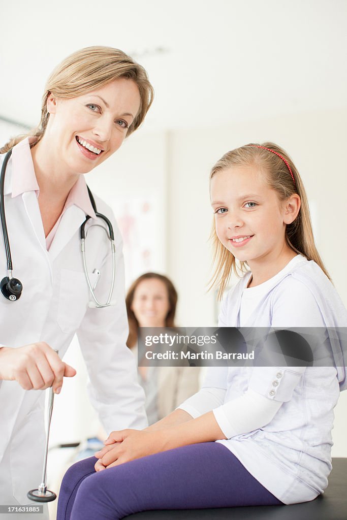 Doctor testing patients reflexes in doctors office