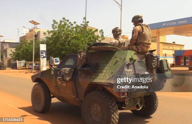 French troops, under escort from Niger forces, withdraw from Niamey, Niger on October 10 after an order of the Niger's military rulers.