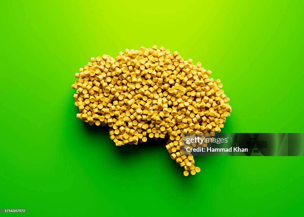Cerebro humano único en 3D hecho de polímeros plásticos amarillos sobre fondo verde brillante Ilustración 3D