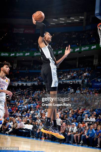 Victor Wembanyama of the San Antonio Spurs dunks the ball against the Oklahoma City Thunder on October 9, 2023 at the Paycom Center in Oklahoma City,...