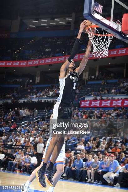 Victor Wembanyama of the San Antonio Spurs dunks the ball against the Oklahoma City Thunder on October 9, 2023 at the Paycom Center in Oklahoma City,...