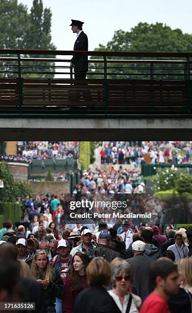 Crowds walk between the courts on day four of the Wimbledon Lawn Tennis Championships at the All England Lawn Tennis and Croquet Club on June 27,...