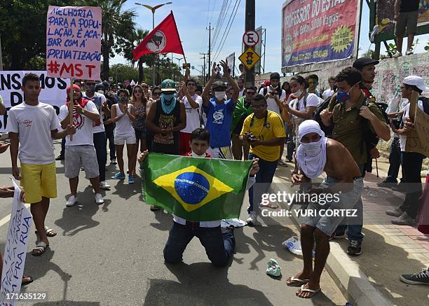 Anti-government protesters demonstrate at the security perimeter two kilometers from the stadium in Fortaleza where Spain and Italy are to clash in...