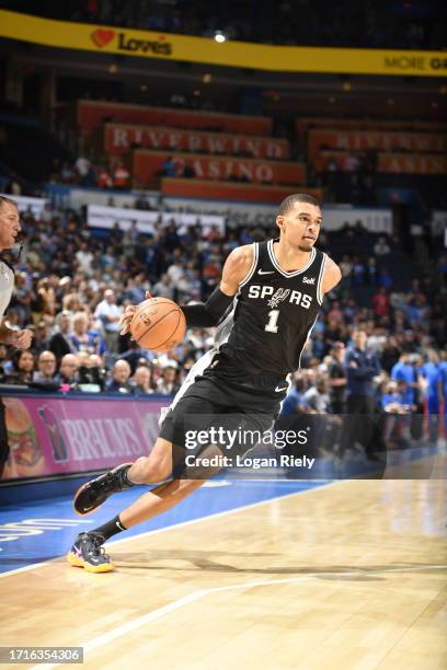 Victor Wembanyama of the San Antonio Spurs moves the ball against the Oklahoma City Thunder on October 9, 2023 at the Paycom Center in Oklahoma City,...