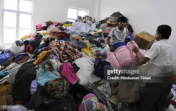 Piles of clothes and blankets to be distributed among the flash flood victims stored in the Sports College on June 27, 2013 in Dehradun, India. Air...