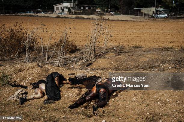 Bodies of Hamas fighters are left out to decompose on the side of the road after Israeli forces secure areas around Re'im, Israel, Tuesday, Oct. 10,...