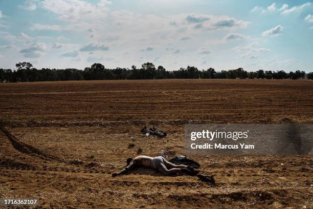 Bodies of Hamas fighters are left out to decompose on the side of the road after Israeli forces secure areas around Re'im, Israel, Tuesday, Oct. 10,...