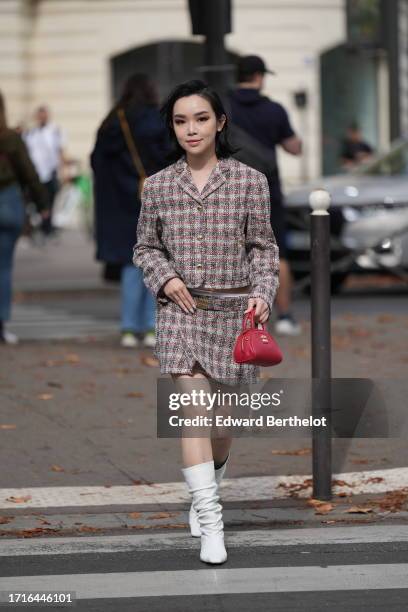 Guest wears a checkered Miu Miu tweed jacket in gray, white Miu Miu underwear, a slit short / mini skirt, a red leather bag from Miu Miu, white long...