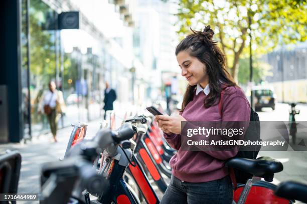 young college student renting e-bike in the city. - enthusiastic stock pictures, royalty-free photos & images