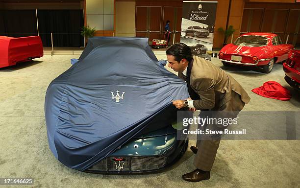 The Maserati MC12 Corsa is uncovered in the morning in the Auto Exotica display at the Canadian International Auto Show at the Metro Toronto...