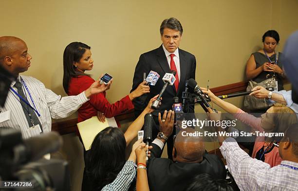 Gov. Rick Perry talks with reporters after speaking to the general session of the 43rd annual National Right to Life Convention at the Hyatt Regency...