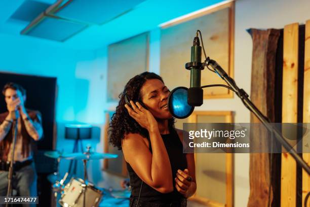 artist recording her vocals in the white room - concentration camp stock pictures, royalty-free photos & images