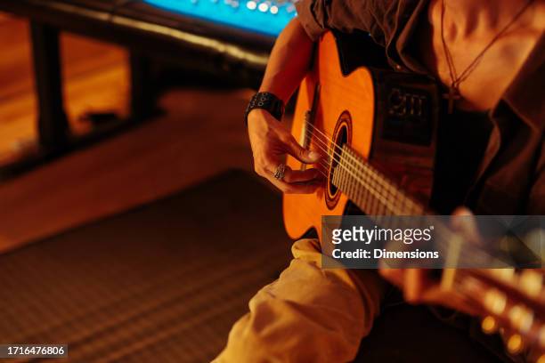 shot of an artist playing guitar in the studio - songwriter stock pictures, royalty-free photos & images