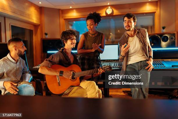 musician friends singing and playing instruments in the music studio - jam session stock pictures, royalty-free photos & images