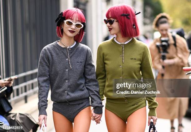 Ami Suzuki and Aya Suzuki of Amiaya are seen wearing Miu Miu gray and green cardigans, Miu Miu underwear, orange stockings and black and white shoes...