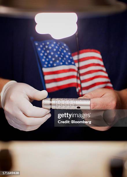An employee works on the ProVari model electronic cigarettes production line at the ProVape Inc. Facility in Monroe, Washington, U.S., on Wednesday,...
