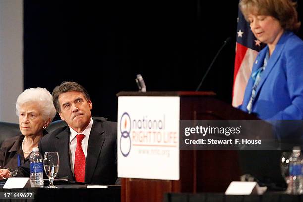 Texas Gov. Rick Perry sits next to Geline B. Williams , chairman of the board of the Natinal Right to Life Committee, while listening to Carol...