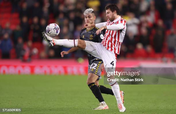 Carlos Alcaraz of Southampton and Ben Pearson of Stoke City in action during the Sky Bet Championship match between Stoke City and Southampton FC at...