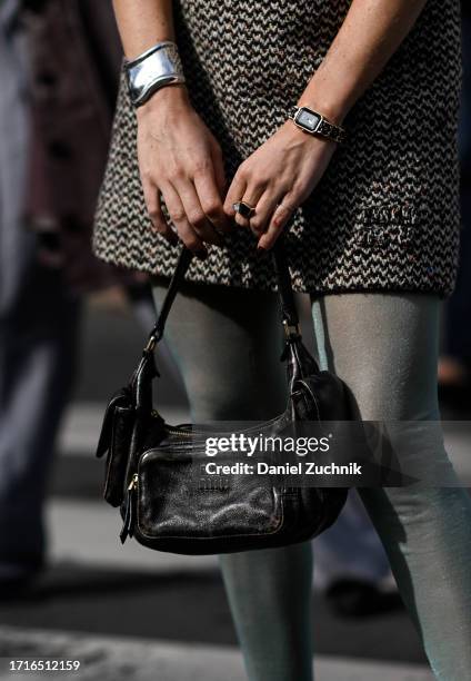 Guest is seen with a black Miu Miu bag outside the Miu Miu show during the Womenswear Spring/Summer 2024 as part of Paris Fashion Week on October 03,...