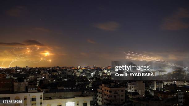 Picture shows rockets fired from the Gaza City being intercepted by Israel's Iron Dome defence missile system on October 10, 2023. Israel said it...