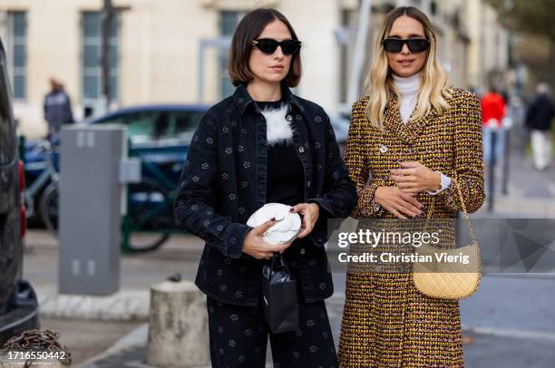 Erika Boldrin wears black jacket, wide leg pants, white bag & Candela Pelizza wears beige bag, orange rust brown black coat outside Chanel during the...