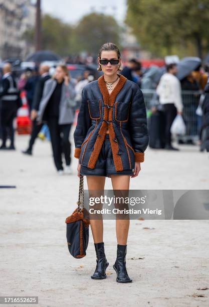 Vera van Erp wears black rust brown shearling jacket, bag, ankle boots outside Chanel during the Womenswear Spring/Summer 2024 as part of Paris...