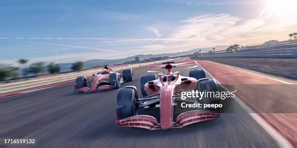 two racing cars moving fast on track - motorsport event stock pictures, royalty-free photos & images