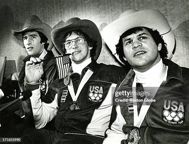 Left to right, U.S. Olympic hockey team players Dave Silk, Jack O'Callahan, and Mike Eruzione talk to press after arriving at Logan Airport, having...